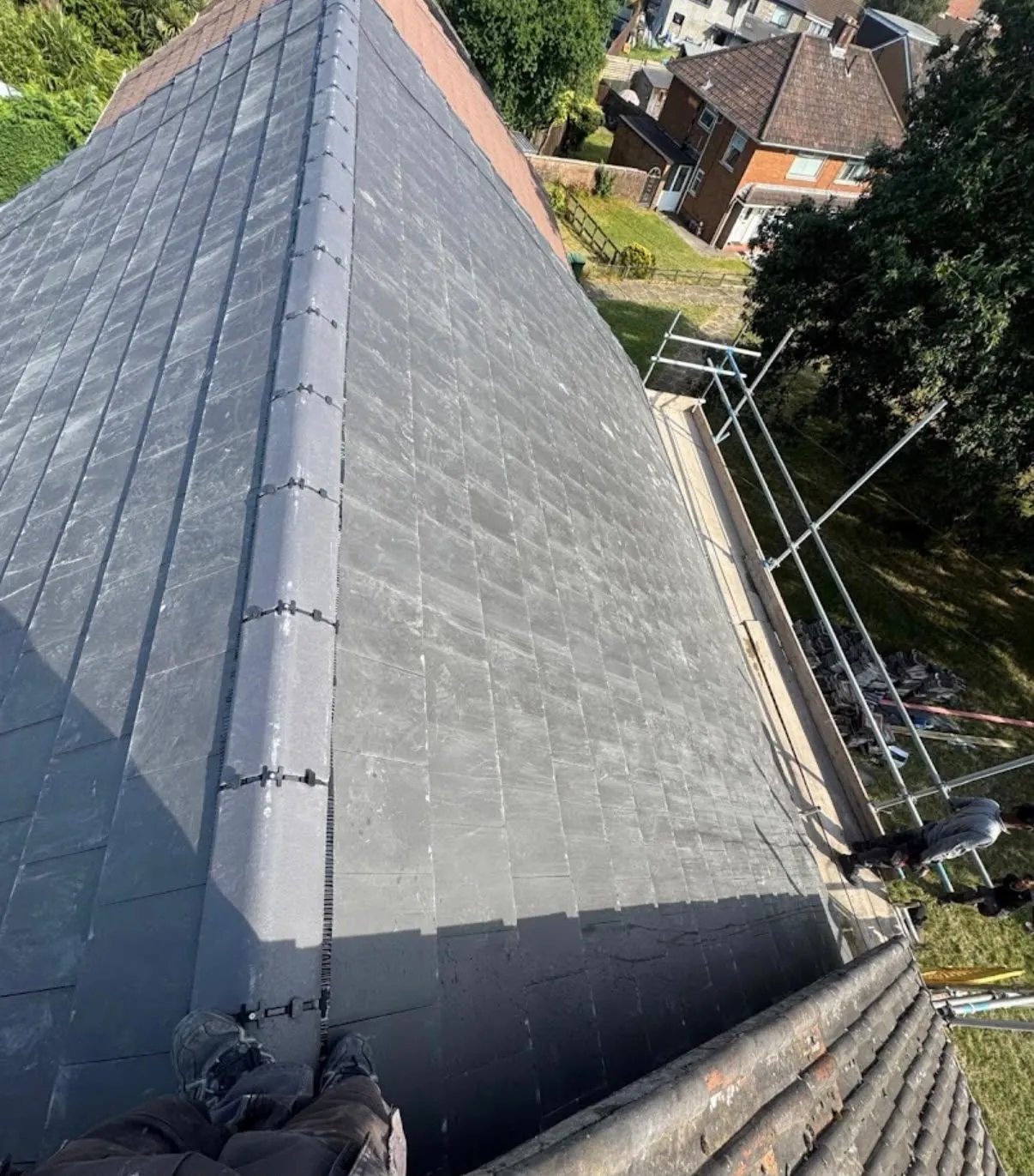 New slate roof with dry-fix ridge installed from scaffolding in Leicester