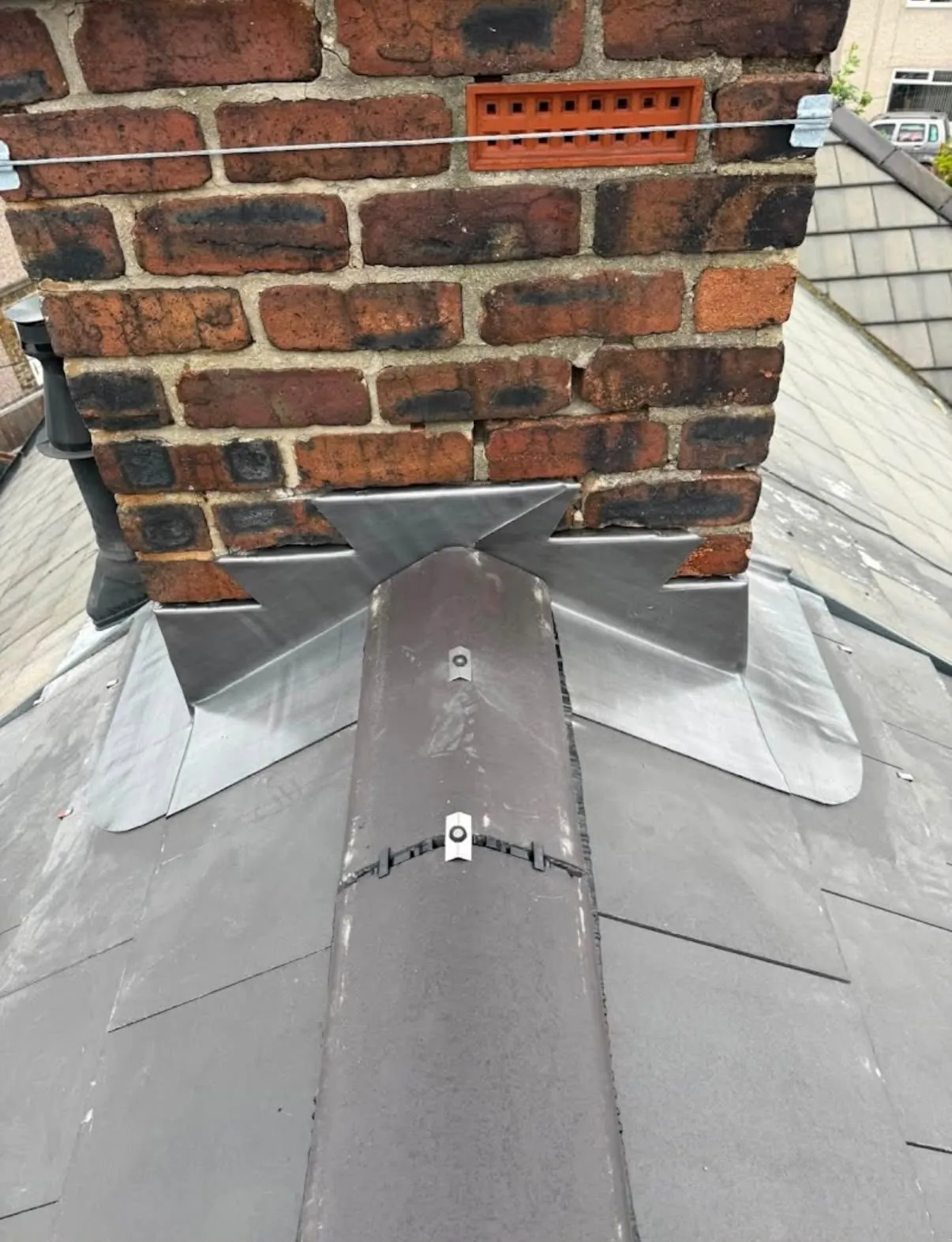 New lead chimney flashing and ridge tiles on a Leicester roof