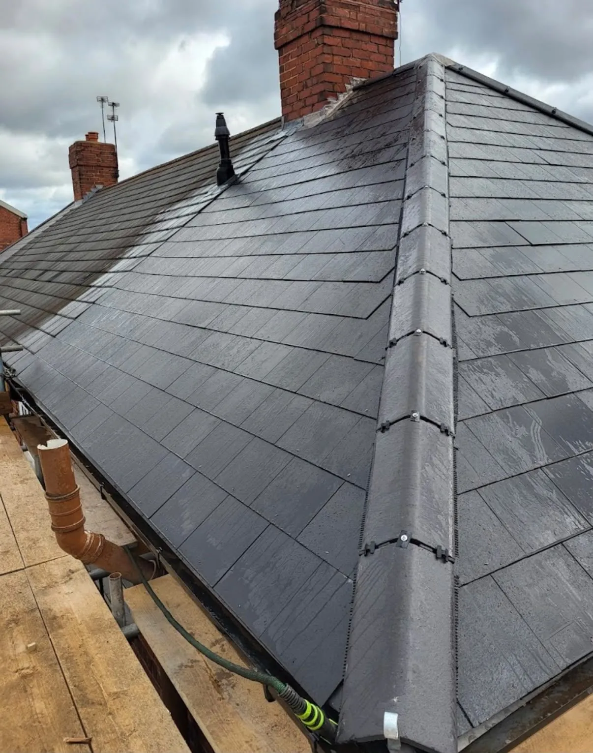 Finished slate re-roof with dry hip system and new vent in Leicester