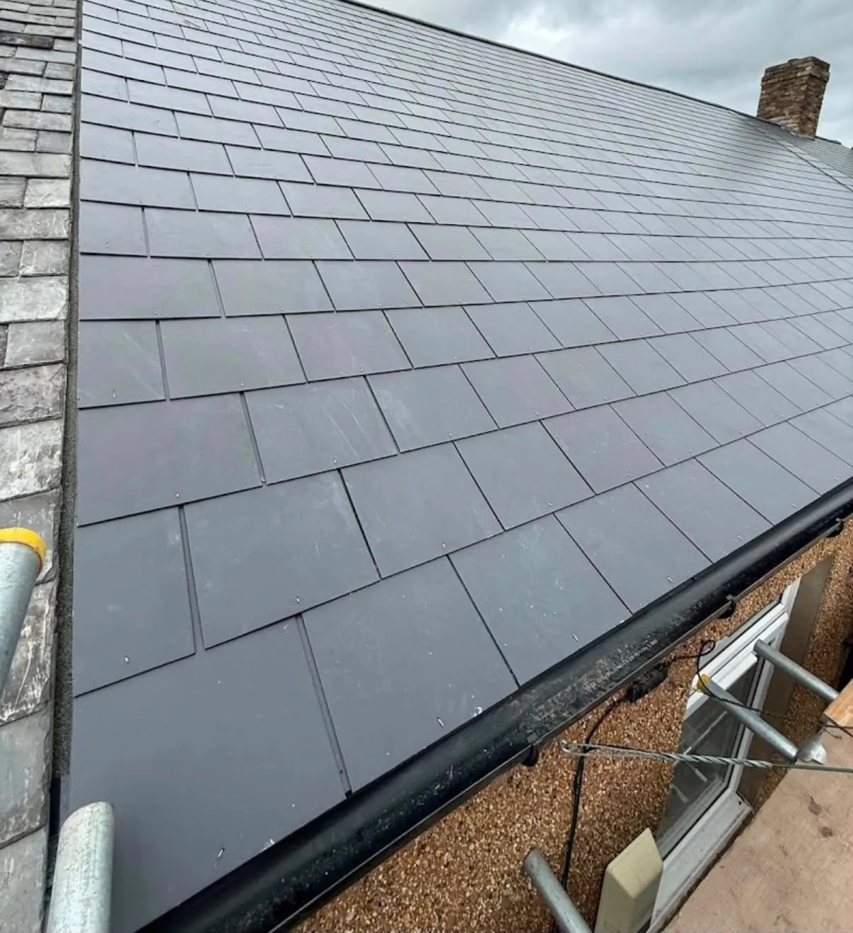 New slate roof with replaced black guttering in Leicester