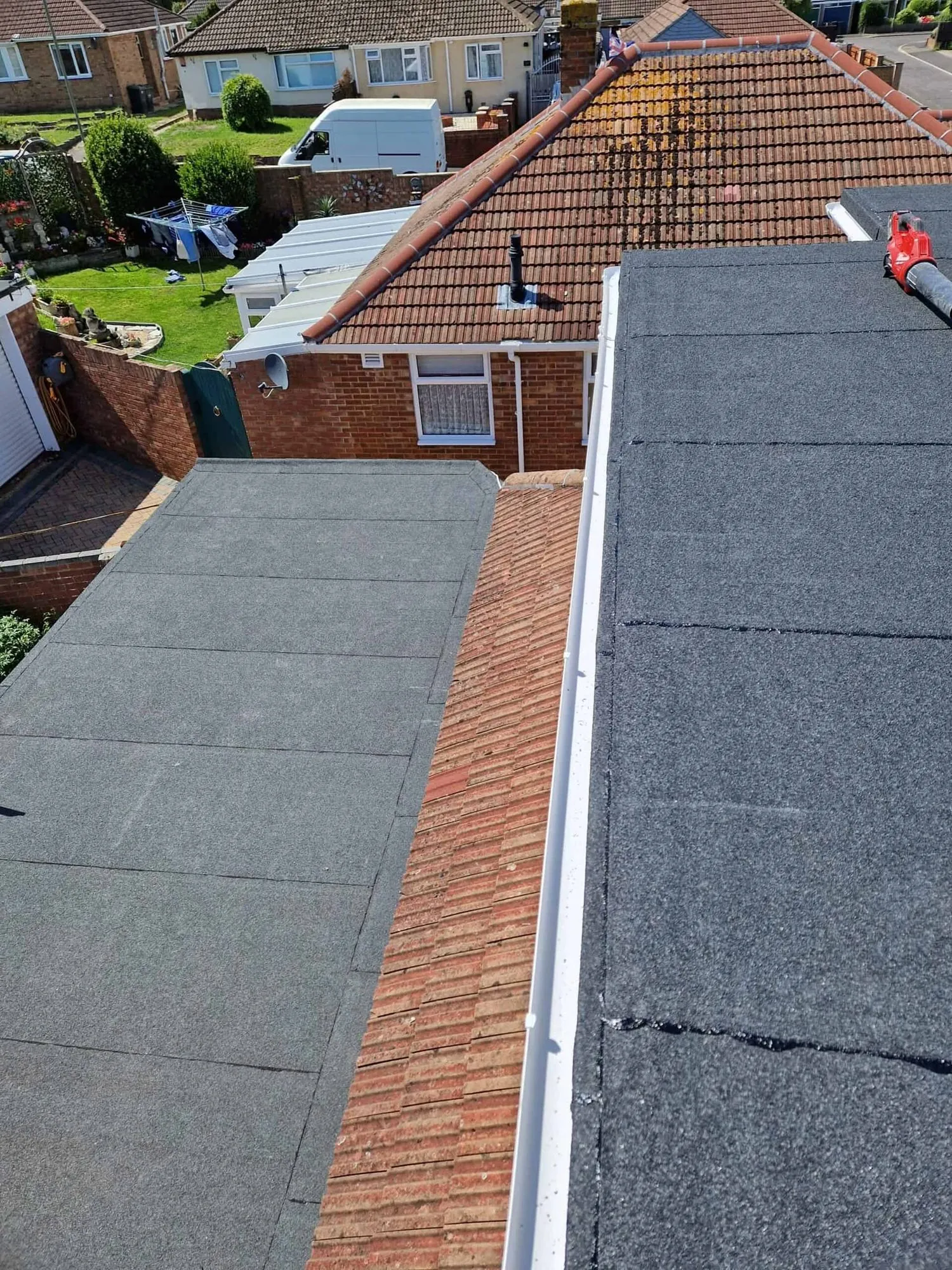 New felt flat roofs with replaced white guttering in Leicester