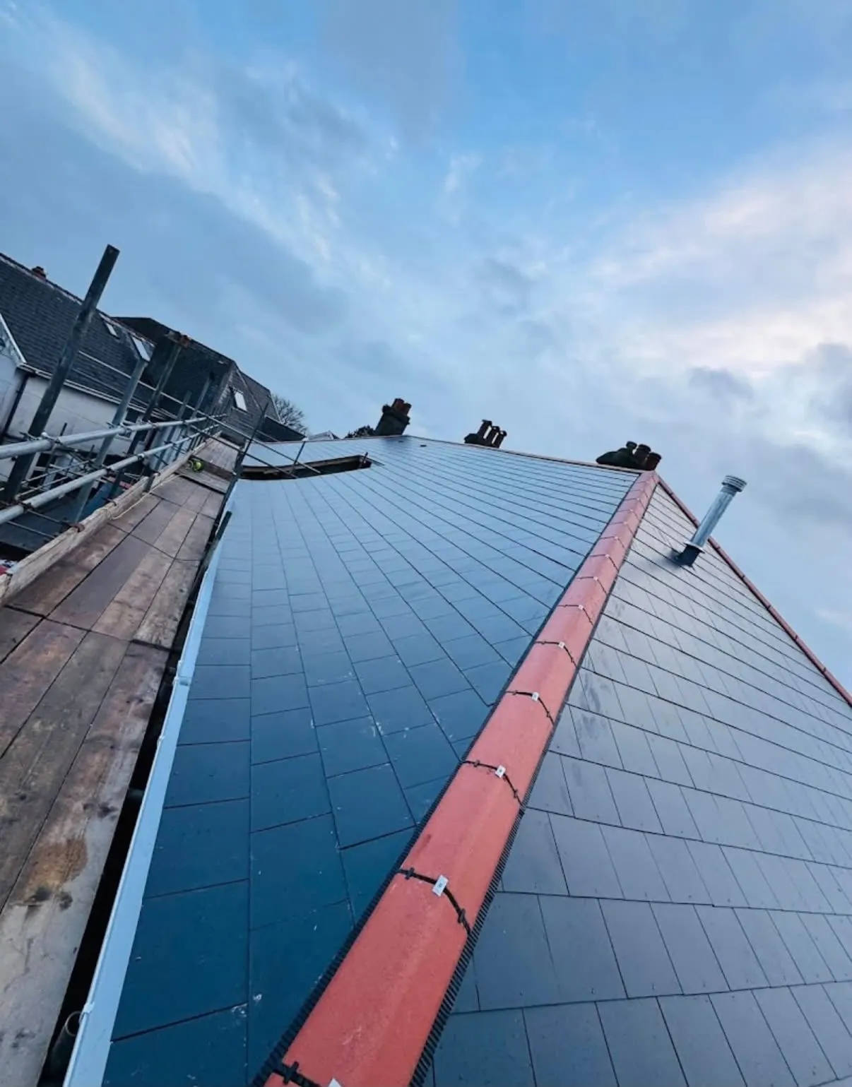 New slate roof replacement in Leicester with red dry-fix ridge