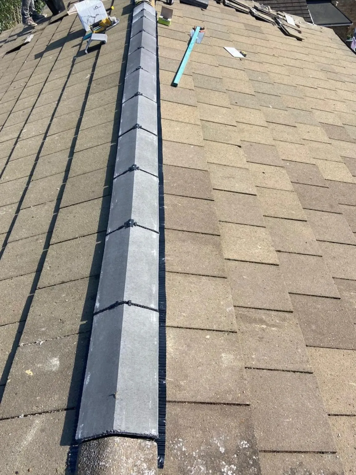 Roof repair replacing an old ridge with new dry-fix ridge tiles in Leicester